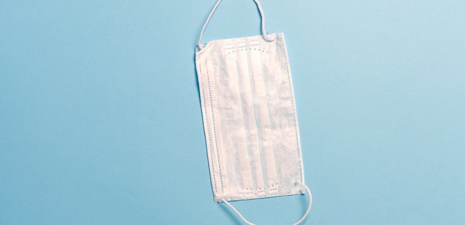 White face mask on blue background